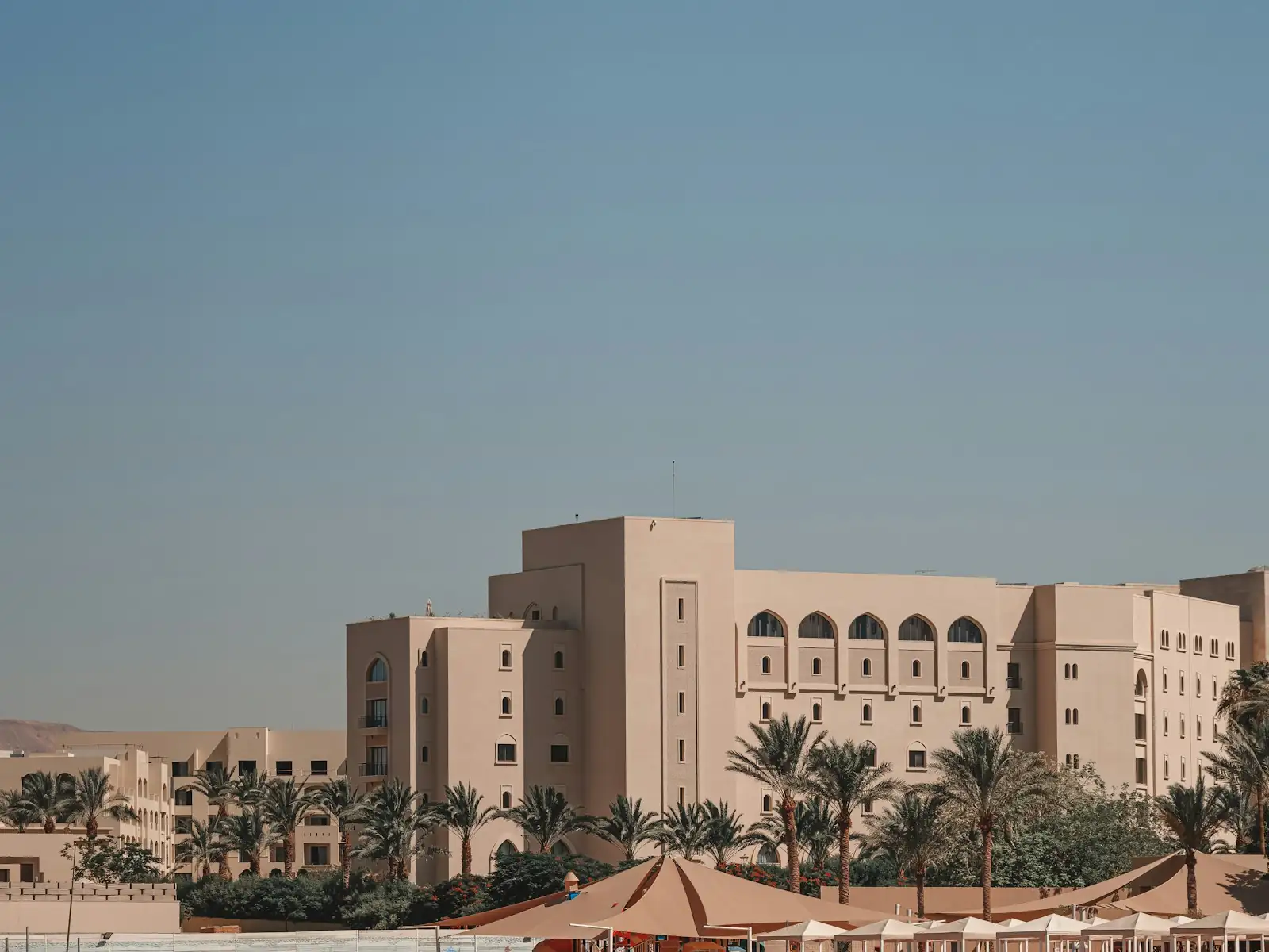 A Red Sea resort seen from the water, palms along the beachfront
