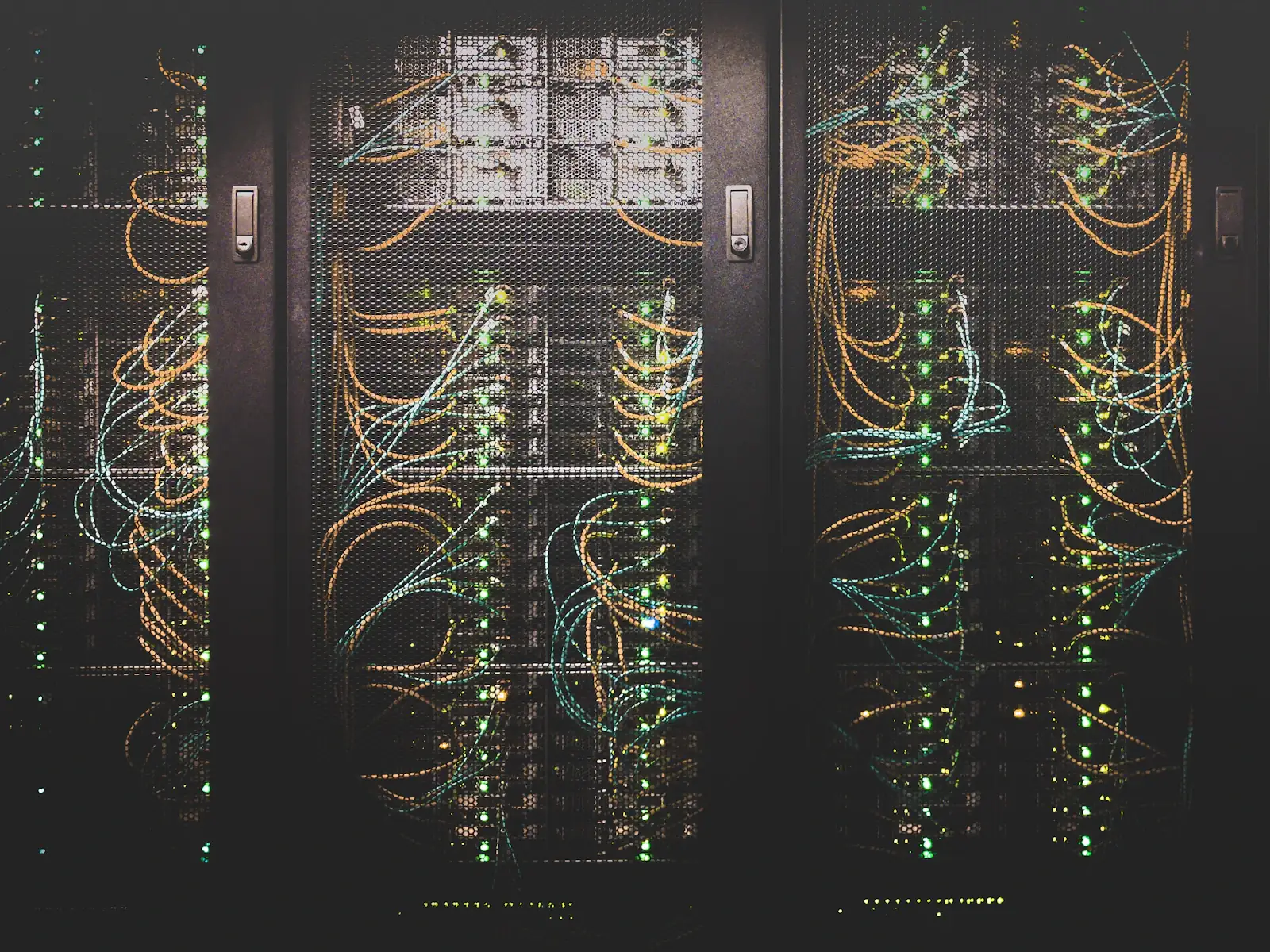 Server racks threaded with colour-coded network cabling