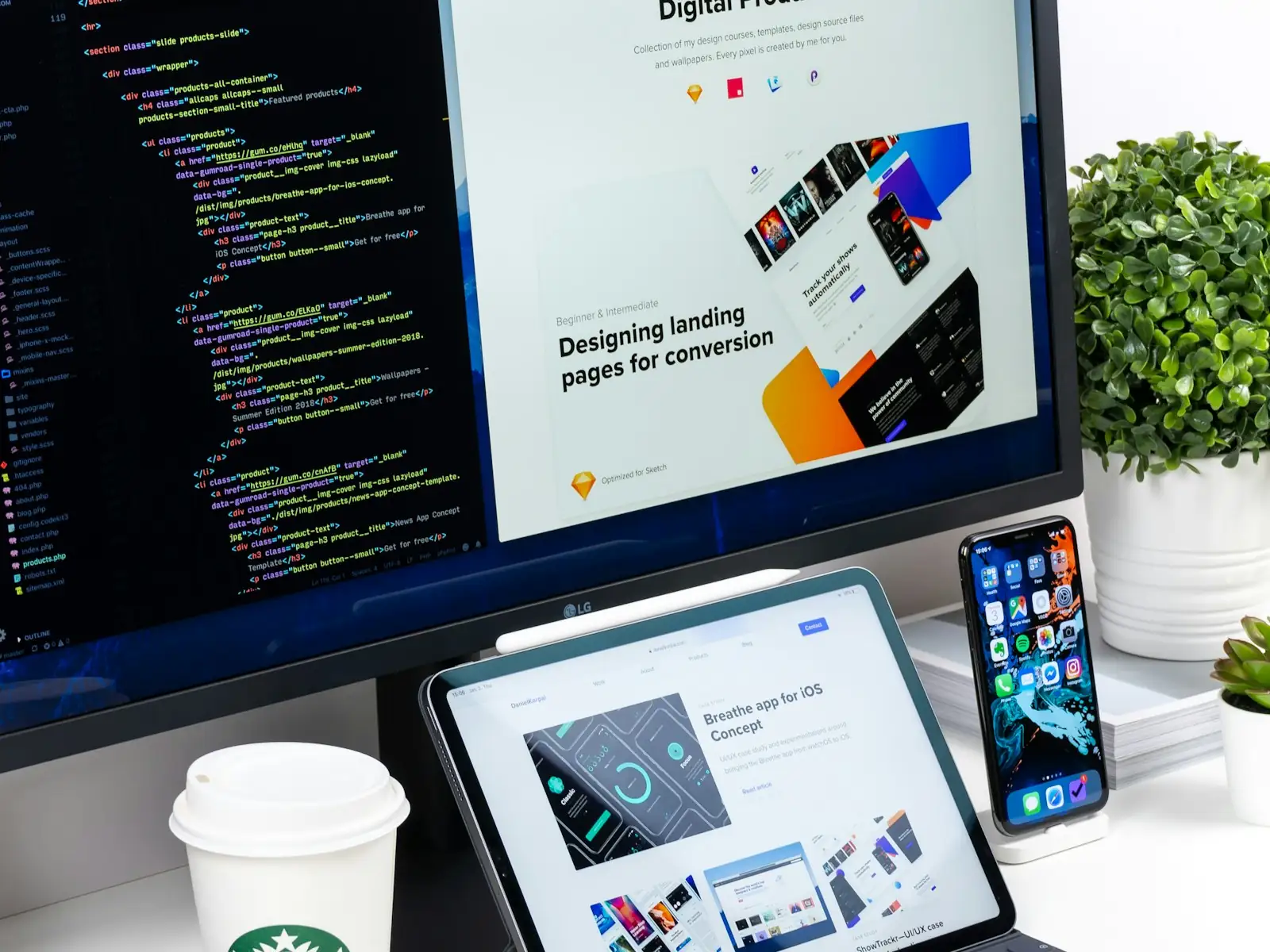 A website design open across a monitor, tablet and phone on a desk